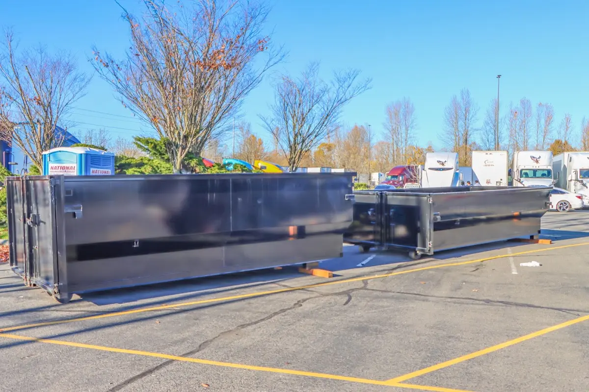 Professional dumpster rental service with roll-off container on residential driveway in Las Cruces